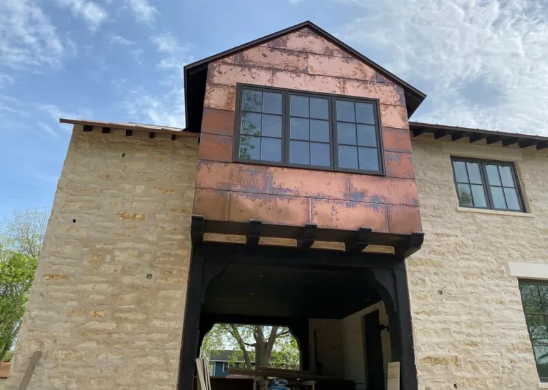Copper metal panel facade on a stone building for Metal Roof Coating in Muscle Shoals